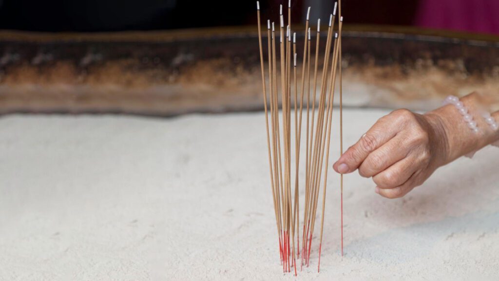 woman taking out incense stick