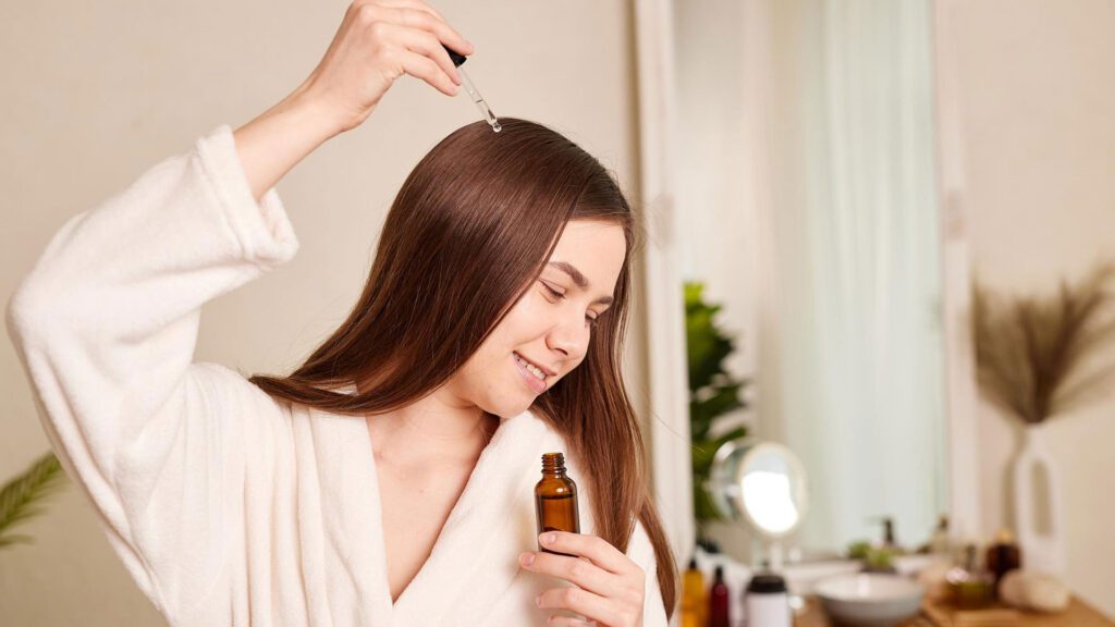 lady putting lavender oil on hairs