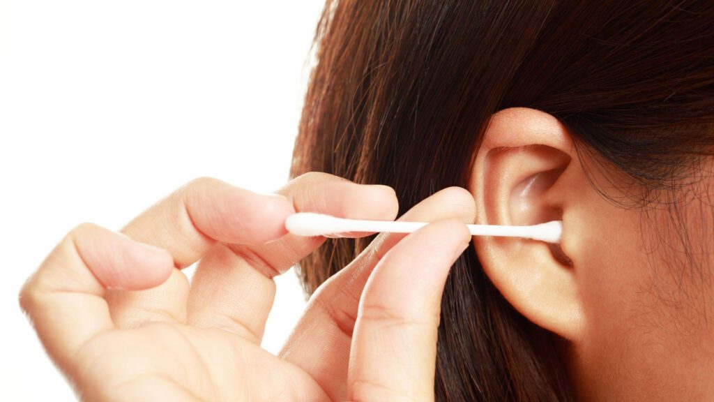 woman taking out ear wax