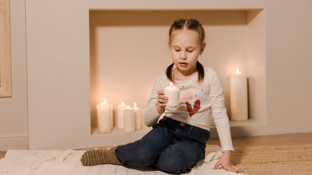 girl playing with candles